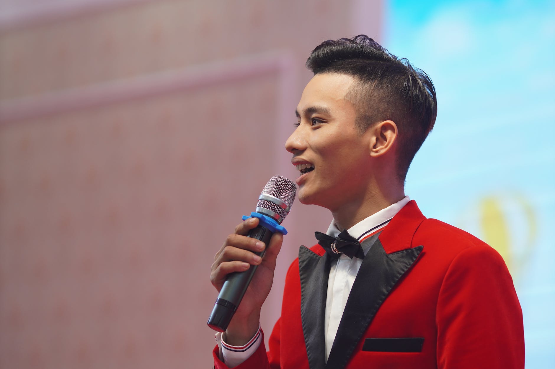 man in red suit with a microphone